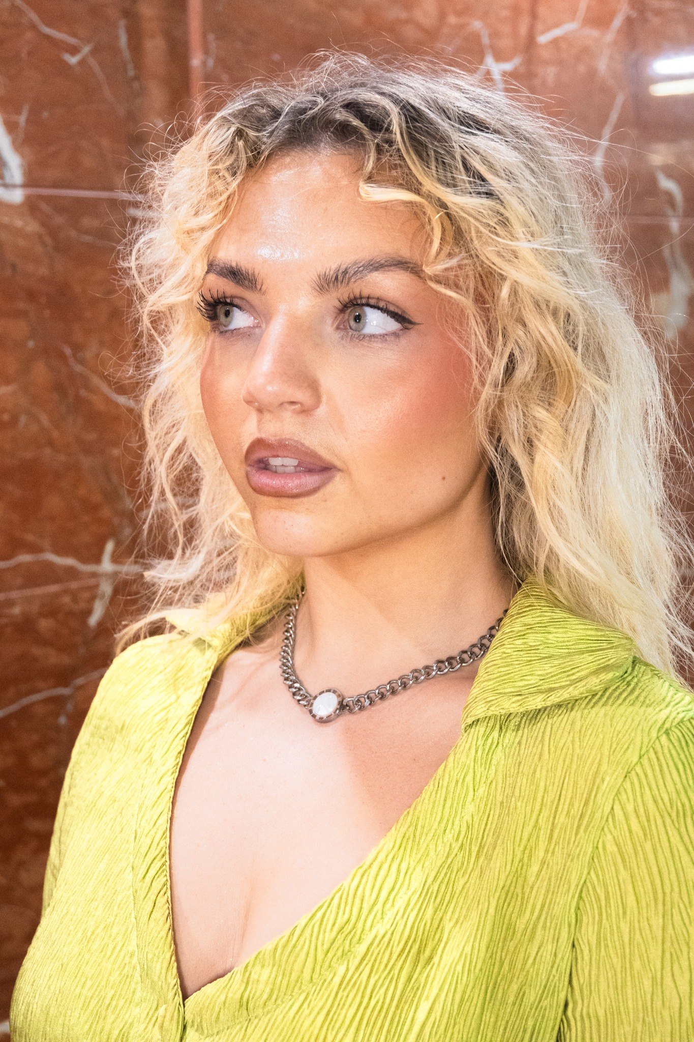 Vi LaVie campaign photography featuring a model in a green blouse